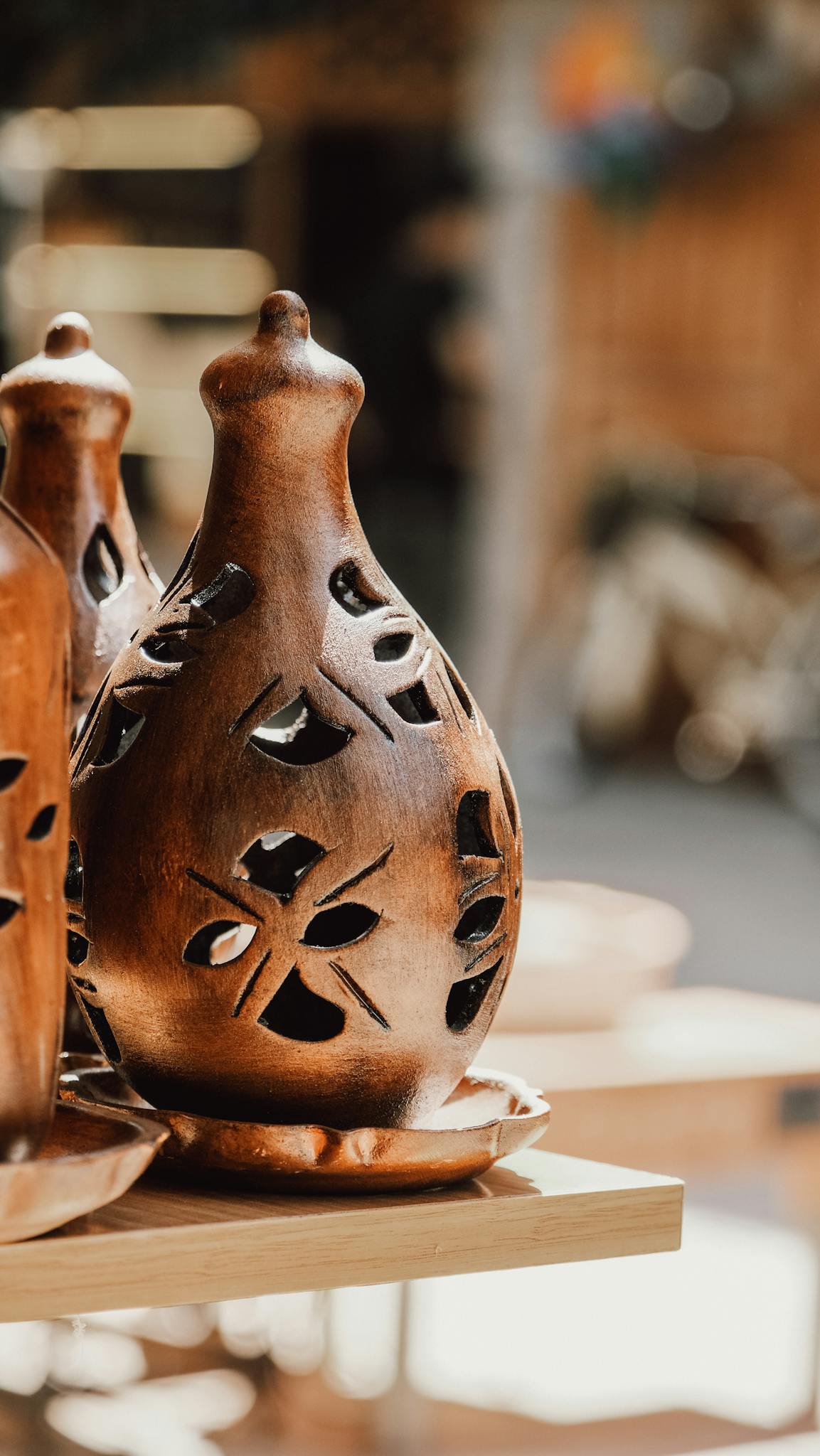 Beautifully carved wooden candle holder showcasing intricate artistry and traditional craftwork.